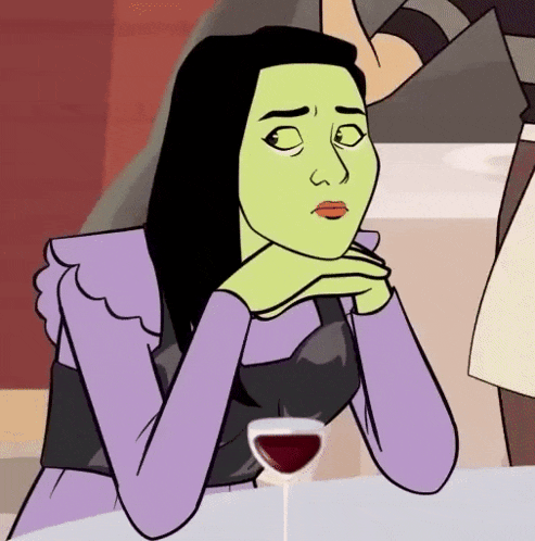 a woman with green hair is sitting at a table with a glass of red wine