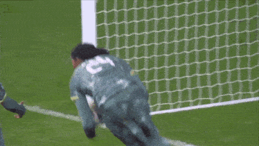a soccer player wearing a jersey that says e on it