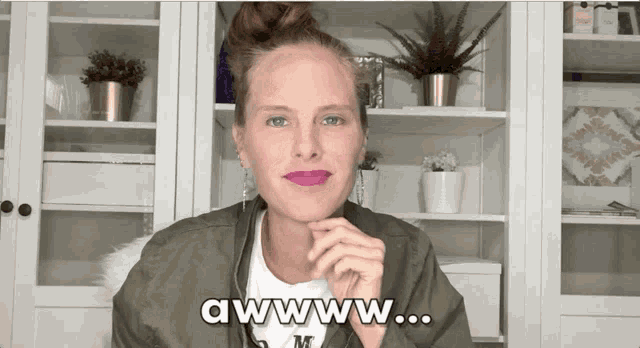 a woman with purple lipstick says awwww on her face