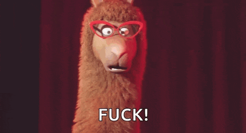a stuffed llama wearing glasses is standing on a stage .