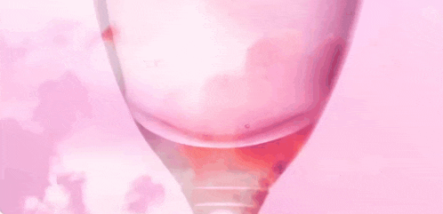 a glass of wine with the words `` you know it might be '' written on it on a pink background .