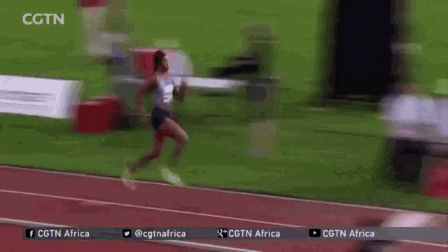 a blurry picture of a woman running on a track with the words cgtn africa on the bottom right