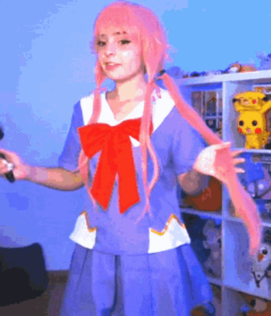 a girl with pink hair is wearing a blue and white dress with a red bow