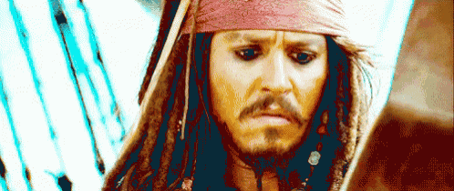 a close up of a man with dreadlocks and a beard wearing a bandana on his head .