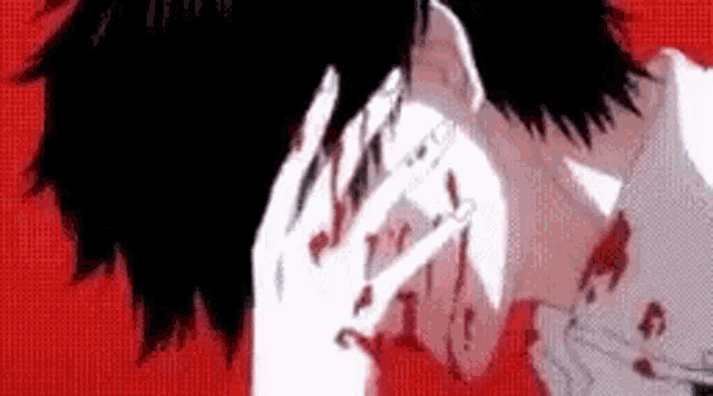 a close up of a person covering their face with their hands on a red background .