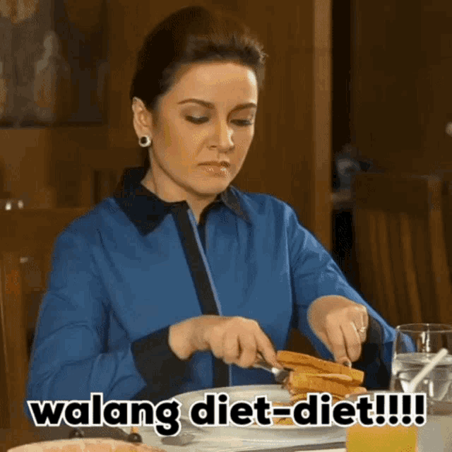 a woman is sitting at a table with a plate of food and the words " walang diet-diet " on the bottom