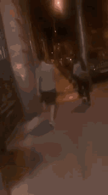 a blurry picture of a group of people walking down a sidewalk at night .