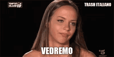 a woman is making a funny face and the words vedremo are on the screen .