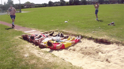 a group of people are laying on the ground in a field