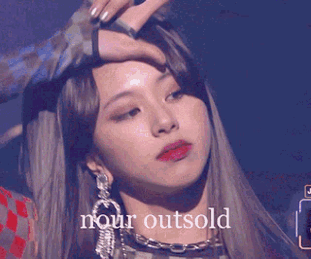 a close up of a woman 's face with the words nour outsold on the bottom .