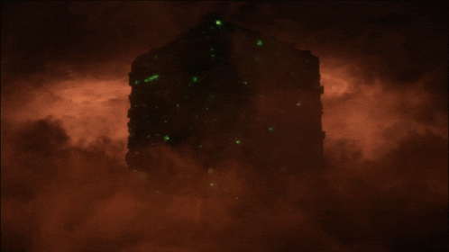 a glowing object in the dark is surrounded by red clouds