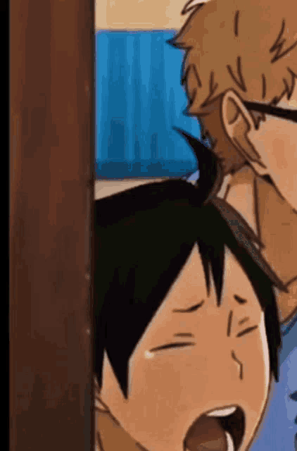 a man and a boy are standing next to each other and the boy is looking at the man .