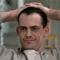 a man with his hands on his head is smiling for the camera