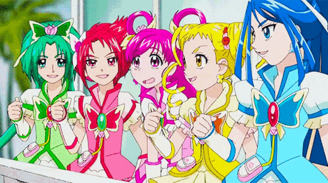 a group of anime girls are standing next to each other on a balcony .