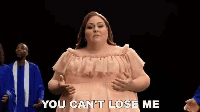a woman singing in front of a group of people with the words you can 't lose me behind her