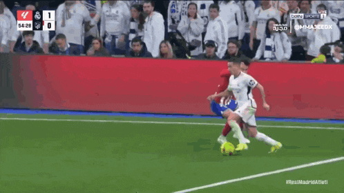 a soccer game is being played with a score of 1-0