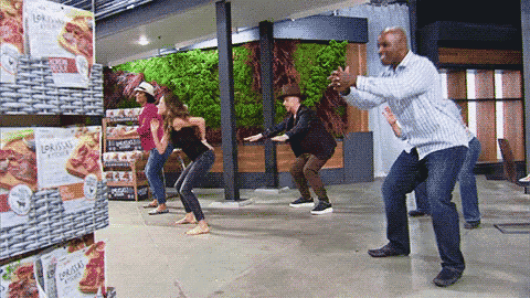 a group of people are dancing in a store in front of a sign that says ' lobsters ' on it