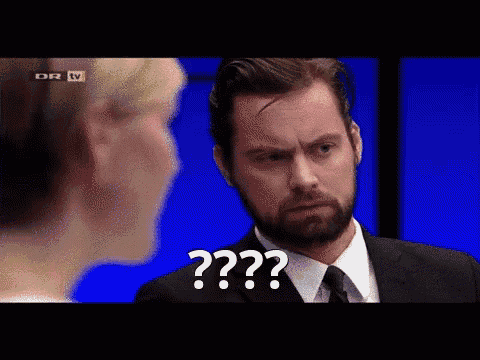 a man in a suit and tie is talking to a woman and the man is saying " question "