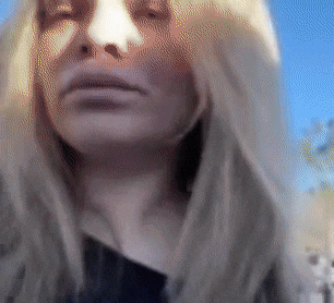 a close up of a woman 's face with the sun shining on her face