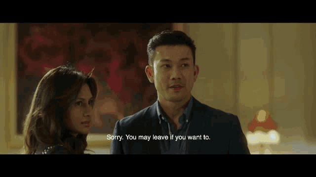 a man and a woman are standing next to each other and the man is saying sorry you may leave if you want to