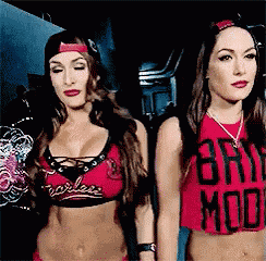 two women are standing next to each other and one of them is wearing a red shirt that says bry mod .