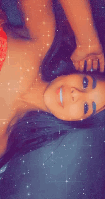 a woman in a red top is smiling and laying down