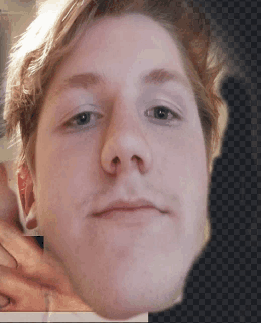 a close up of a young man 's face with a checkered background