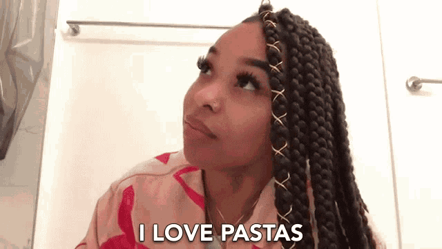a woman with braids says " i love pastas " while looking up