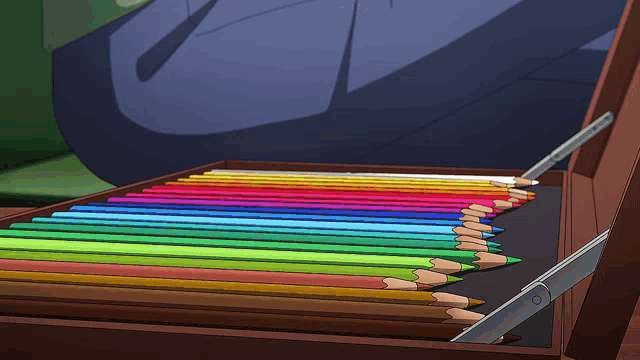 a wooden box filled with colored pencils in a rainbow of colors