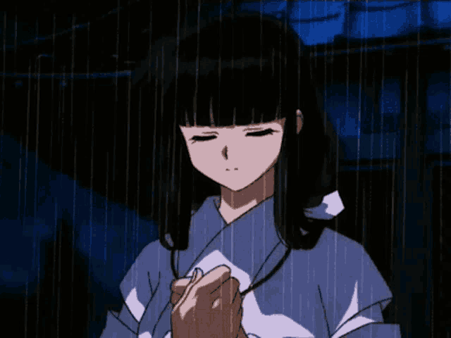 a girl in a kimono is standing in the rain holding a piece of paper