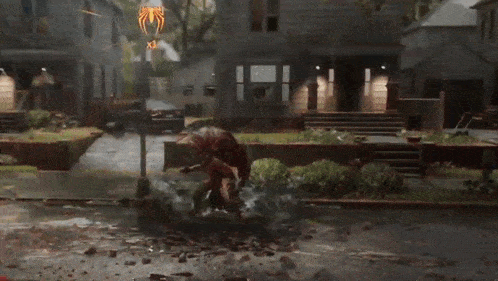 a video game scene with a spider-man fighting a monster on the street