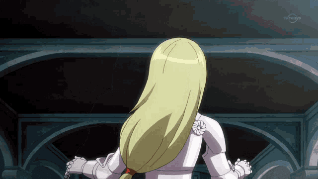 a girl with blonde hair is standing in front of a tv screen that says tv tokyd