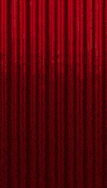 a red curtain is open to a stage with confetti falling from it