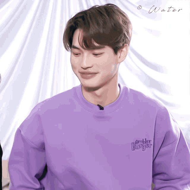 a man wearing a purple sweater with the word rambler on the front