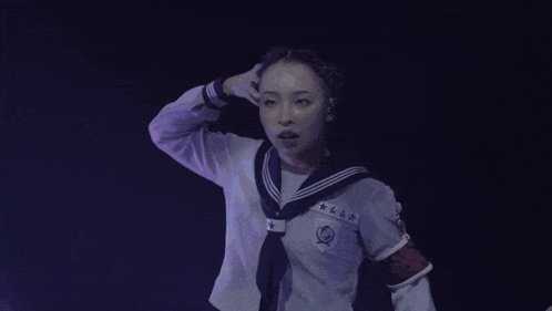 a girl in a school uniform holds a microphone