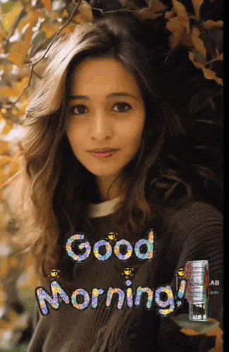 a woman is wearing a sweater with the words good morning on it