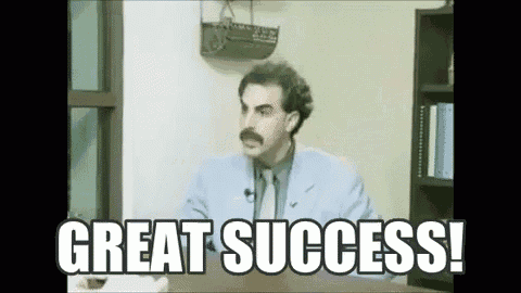 a man with a mustache is sitting at a desk with the words `` great success '' written above him .