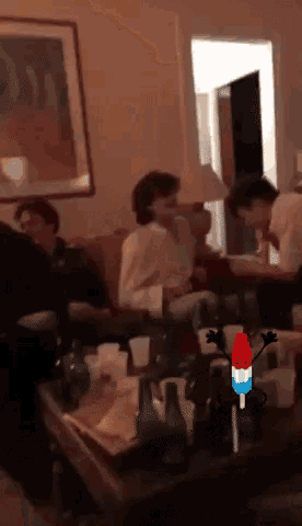 a group of people are sitting around a table with bottles of beer