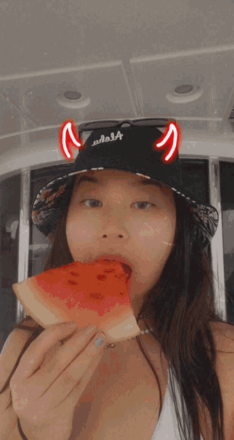 a girl wearing a black hat with the word adel4 on it