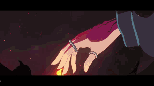 a close up of a person 's hand in a dark room with red lights .