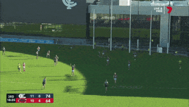 a soccer game is being played in front of a large building that says live & free