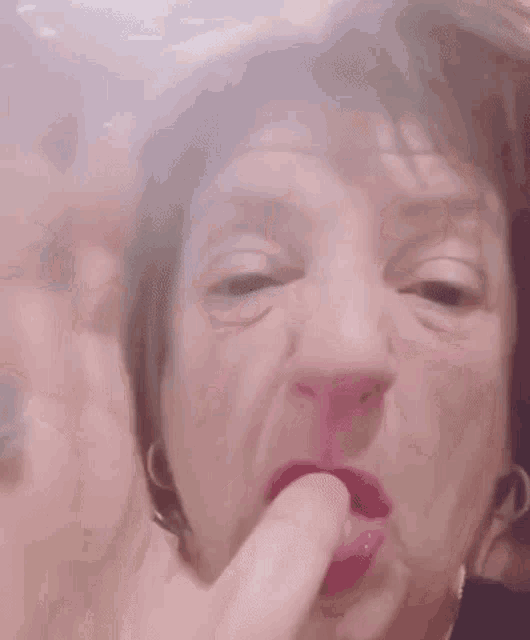 a close up of a woman making a funny face