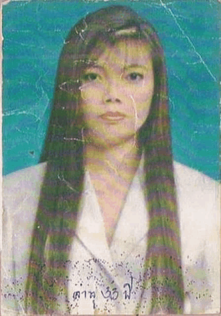 a woman with long hair is wearing a white jacket and has the number 35 on her passport