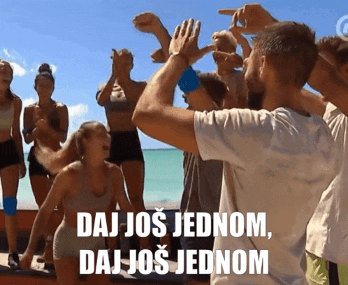 a group of people on a beach with the words " daj još jednom " on the bottom right