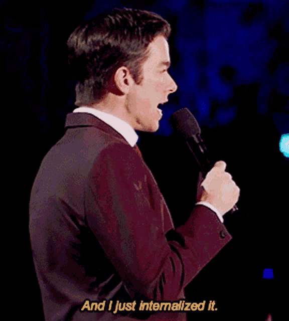 a man in a suit speaking into a microphone with the words " and i just internalized it " next to him