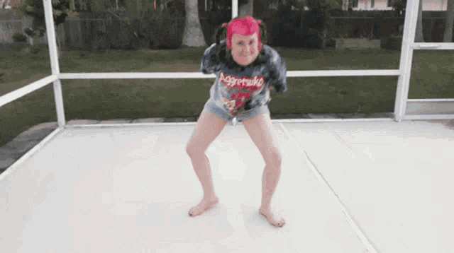 a girl with pink hair and a shirt that says nuggets