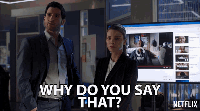 a man and a woman are standing in front of a netflix monitor