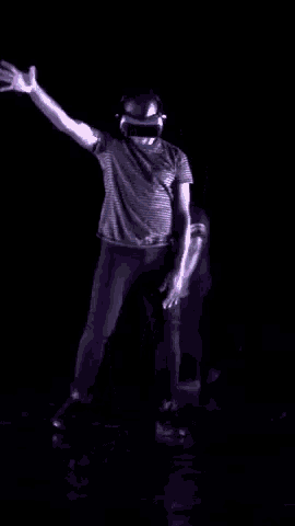 a man wearing headphones and a virtual reality headset is dancing