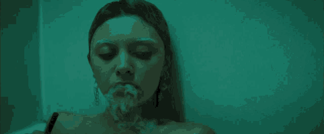 a woman is laying in a bathtub with smoke coming out of her mouth .