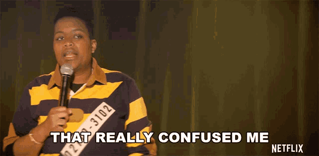 a man in a yellow and blue striped shirt holds a microphone and says that really confused me netflix
